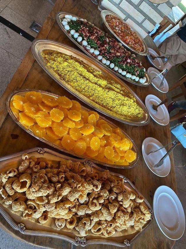 Acompanhamentos da feijoada: torresmo, laranja, farofa e couve com ovos de codorna
